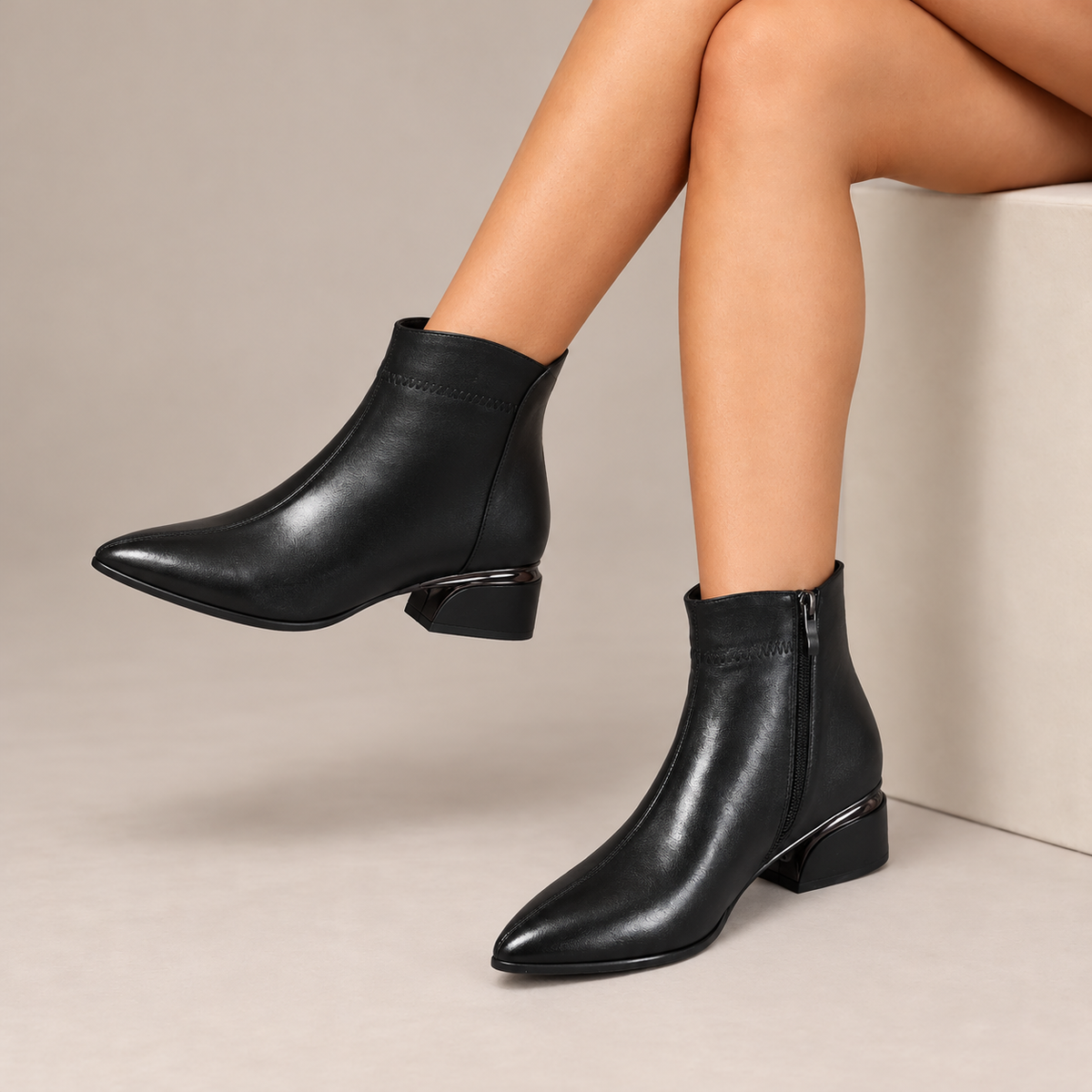 Cressida™ | Pointed-Toe Low Heel Ankle Boots in Black, worn in a beige studio