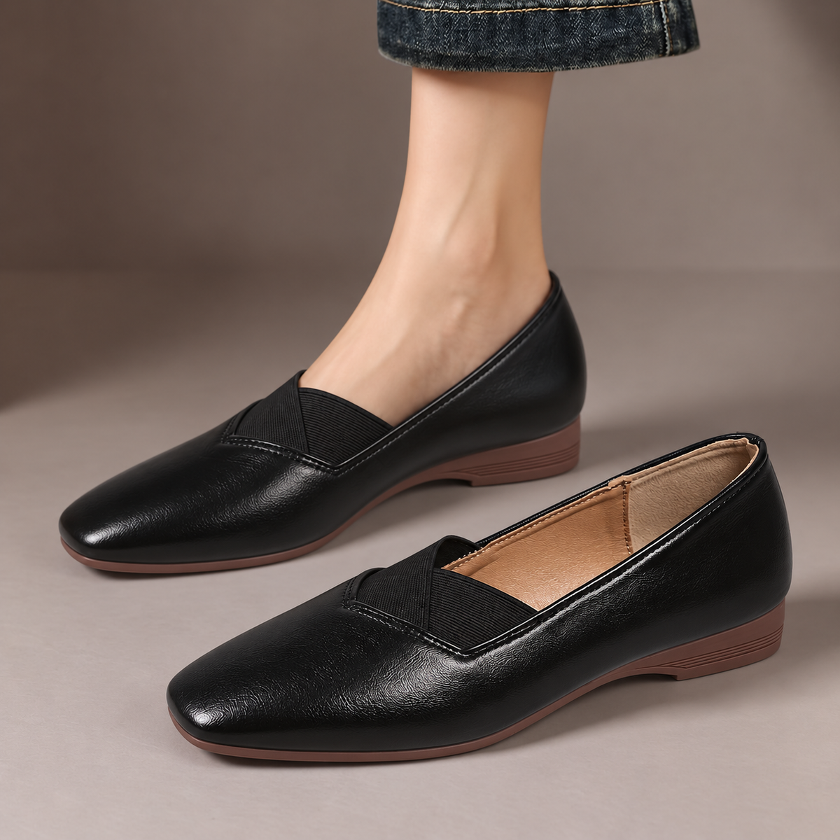 Delphine™ | Cross-Strap Square-Toe Flats — one worn shoe and one matching shoe in a taupe studio