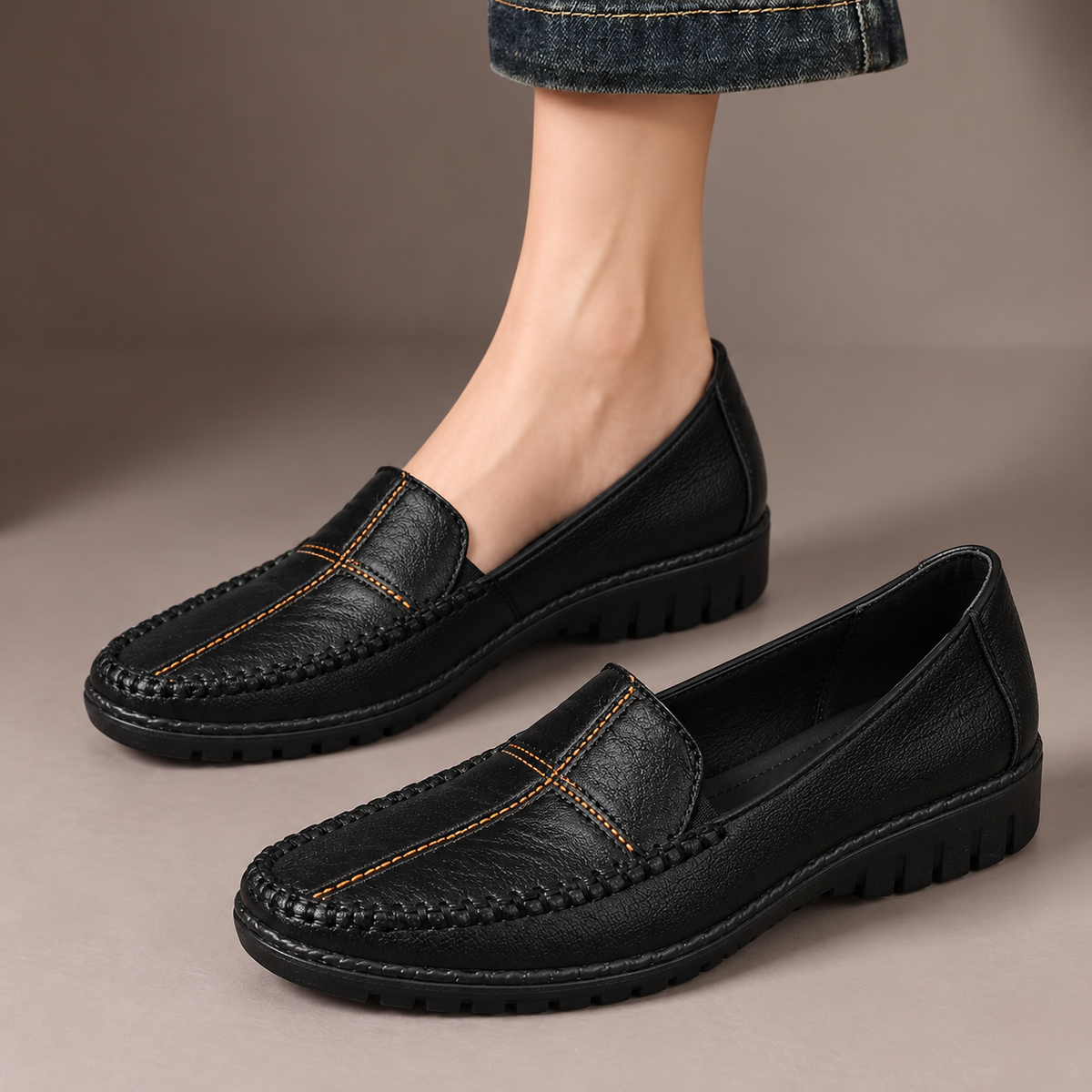 Edith™ | Stitched Comfort Loafers — one worn shoe and one matching shoe in a taupe studio