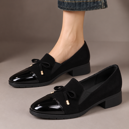 Hattie™ | Patent Toe Bow Loafers — one worn shoe and one matching shoe in a taupe studio