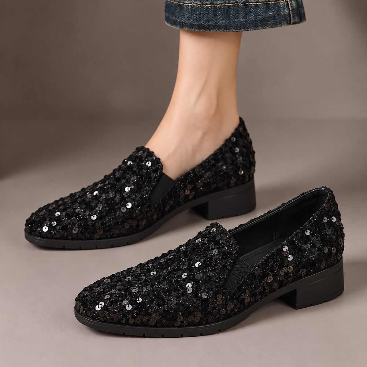 Mabel™ | Sequin Slip-On Loafers — one worn shoe and one matching shoe in a taupe studio