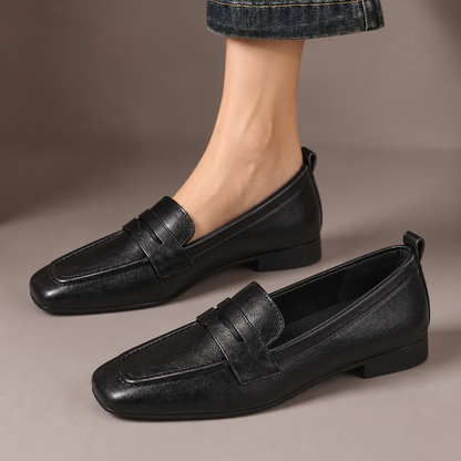 Ottilie™ | Square-Toe Penny Loafers — one worn shoe and one matching shoe in a taupe studio
