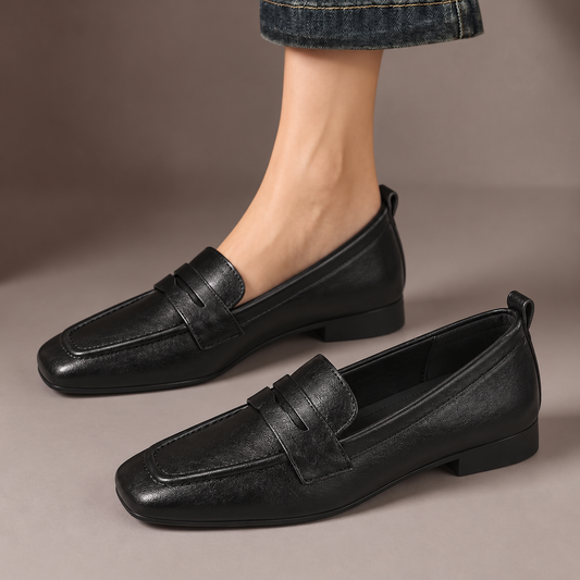 Ottilie™ | Square-Toe Penny Loafers — one worn shoe and one matching shoe in a taupe studio